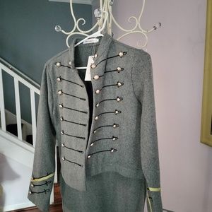 Dressy gray blazer with black rope detail and brass colored buttons and tails.